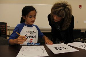 student in language arts class with teacher at bainbridge academy